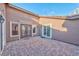 Stunning courtyard featuring brick pavers and decorative double door main entry to the home at 8212 Cabin Springs Ave, Las Vegas, NV 89131