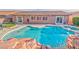 Backyard pool features a built-in spa with rock features, colorful flowers and plenty of space for entertaining at 8212 Cabin Springs Ave, Las Vegas, NV 89131