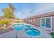 Inviting backyard with a beautiful pool, spa, and mature landscaping creating a private retreat at 8212 Cabin Springs Ave, Las Vegas, NV 89131