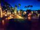 Stunning backyard at night with landscape lighting highlighting the trees and walkway at 8225 Fulton Ranch St, Las Vegas, NV 89131