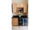 Bar area featuring light wood cabinets, black countertop, and dual beverage refrigerators at 8225 Fulton Ranch St, Las Vegas, NV 89131