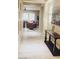 Hallway featuring wood floors, recessed art niche, and views into the living area at 8225 Fulton Ranch St, Las Vegas, NV 89131