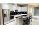 Modern kitchen featuring white cabinets, stainless steel appliances, and an island with seating at 8225 Fulton Ranch St, Las Vegas, NV 89131