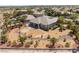 Desert home featuring a large backyard with tropical palm trees and river rock landscaping at 8536 Grand Palms Cir, Las Vegas, NV 89131