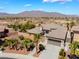 Aerial view of a meticulously landscaped property with lush greenery, and a private desert setting at 8536 Grand Palms Cir, Las Vegas, NV 89131