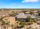 Spacious desert home with lush tropical landscaping, including palm trees and decorative rock at 8536 Grand Palms Cir, Las Vegas, NV 89131