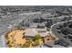 This aerial view presents a home with desert landscaping nestled within its community and the adjacent golf course at 8536 Grand Palms Cir, Las Vegas, NV 89131