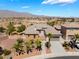 Expansive single-Gathering house showcasing meticulous landscaping, and a desert mountain backdrop at 8536 Grand Palms Cir, Las Vegas, NV 89131