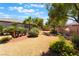Landscaped backyard with desert foliage, gravel, and mature trees at 8536 Grand Palms Cir, Las Vegas, NV 89131