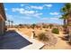 Expansive backyard with gravel landscaping and mountain views under blue skies at 8536 Grand Palms Cir, Las Vegas, NV 89131