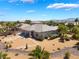 Expansive backyard featuring desert landscaping, mature palm trees, and a charming stone pathway at 8536 Grand Palms Cir, Las Vegas, NV 89131