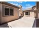 Spacious backyard with an outdoor fireplace, neutral color palette, and privacy at 8536 Grand Palms Cir, Las Vegas, NV 89131