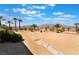 Landscaped backyard with stone pathway, desert vegetation, and a view of the surrounding desert landscape at 8536 Grand Palms Cir, Las Vegas, NV 89131