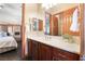 Bright bathroom showcases cabinets, a framed mirror, and a view into the bedroom at 8536 Grand Palms Cir, Las Vegas, NV 89131