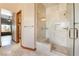 A modern bathroom features a glass-enclosed shower with white marble and a built-in bench at 8536 Grand Palms Cir, Las Vegas, NV 89131
