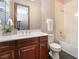 Bathroom showcasing a tub, toilet and single sink vanity with wood look cabinets at 8536 Grand Palms Cir, Las Vegas, NV 89131