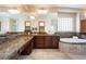 This bathroom features dual vanities, a soaking tub, and granite countertops at 8536 Grand Palms Cir, Las Vegas, NV 89131