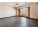 Spacious bedroom with wood-look flooring, a ceiling fan, and a large window with decorative curtains at 8536 Grand Palms Cir, Las Vegas, NV 89131