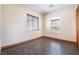 Clean bedroom with hardwood flooring and natural light from two windows at 8536 Grand Palms Cir, Las Vegas, NV 89131