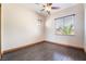 Bright bedroom with hardwood floors, ceiling fan, and natural light from a large window at 8536 Grand Palms Cir, Las Vegas, NV 89131