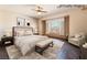 This virtually staged bedroom features dark wood floors, a ceiling fan, and bright natural light at 8536 Grand Palms Cir, Las Vegas, NV 89131