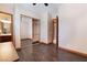 Bedroom with wood look floors, mirrored closet doors and view to bathroom at 8536 Grand Palms Cir, Las Vegas, NV 89131