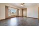 Bedroom with wood-look flooring, a ceiling fan, and a large window offering lots of natural light at 8536 Grand Palms Cir, Las Vegas, NV 89131