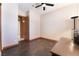 Neutral-toned bedroom with dark wood-look floors and ceiling fan at 8536 Grand Palms Cir, Las Vegas, NV 89131