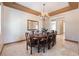 Formal dining room featuring a decorative chandelier and a large table with seating for eight at 8536 Grand Palms Cir, Las Vegas, NV 89131