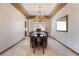 Formal dining room featuring a decorative chandelier and a large table with seating for eight at 8536 Grand Palms Cir, Las Vegas, NV 89131