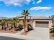 Beautiful home with desert landscape, a spacious driveway, and a well-manicured front yard at 8536 Grand Palms Cir, Las Vegas, NV 89131