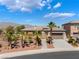 Stunning single-Gathering home featuring desert landscaping and mature palm trees, creating curb appeal at 8536 Grand Palms Cir, Las Vegas, NV 89131