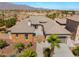 A well-manicured front exterior, desert landscaping, and stone accents add character and curb appeal at 8536 Grand Palms Cir, Las Vegas, NV 89131