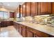 Gourmet kitchen featuring custom wood cabinets, granite countertops, and modern backsplash at 8536 Grand Palms Cir, Las Vegas, NV 89131