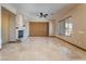 Spacious living room with a stone fireplace, ceiling fan, and beautiful tile flooring at 8536 Grand Palms Cir, Las Vegas, NV 89131