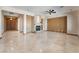 Open living room with a stone fireplace, recessed lighting, and elegant tiled floors at 8536 Grand Palms Cir, Las Vegas, NV 89131