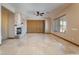 Spacious living room with a stone fireplace, ceiling fan, and beautiful tile flooring at 8536 Grand Palms Cir, Las Vegas, NV 89131