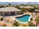 Aerial view of landscaped backyard with stone pathway leading to a private backyard pool with mature landscaping at 8536 Grand Palms Cir, Las Vegas, NV 89131
