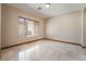Empty room with neutral colors, tiled flooring, and natural lighting at 8536 Grand Palms Cir, Las Vegas, NV 89131