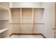 Bright walk-in closet includes custom shelving and rods for ample storage at 8536 Grand Palms Cir, Las Vegas, NV 89131