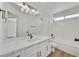 Elegant bathroom featuring white countertops, cabinetry, modern fixtures, and bathtub at 8904 Meisenheimer Ave, Las Vegas, NV 89143