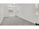 Bright bedroom with neutral carpet, and two windows with neighborhood views at 8904 Meisenheimer Ave, Las Vegas, NV 89143