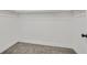 Spacious walk-in closet with white shelving and trim and neutral carpet at 8904 Meisenheimer Ave, Las Vegas, NV 89143