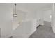 Bright hallway area with gray carpet, white walls and trim, and modern light fixture at 8904 Meisenheimer Ave, Las Vegas, NV 89143