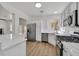 Well lit kitchen featuring stainless steel appliances, white cabinets, and wood style flooring at 8904 Meisenheimer Ave, Las Vegas, NV 89143