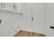 Bright laundry room features storage cabinets and convenient access to the outside at 8904 Meisenheimer Ave, Las Vegas, NV 89143