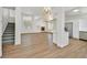 Open floor plan with modern wood floors, a fireplace, and a view into the bright kitchen at 8904 Meisenheimer Ave, Las Vegas, NV 89143