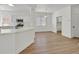 Open floor plan with bright walls, modern fixtures, a kitchen bar, and wood style floors at 8904 Meisenheimer Ave, Las Vegas, NV 89143