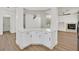 Open floor plan with kitchen bar, all white walls, modern fixtures, and wood style floors at 8904 Meisenheimer Ave, Las Vegas, NV 89143
