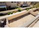 Backyard with a clean gravel area, landscaped shrubs, and a pristine white fence ensuring privacy at 10010 Aspen Rose St # 102, Las Vegas, NV 89183